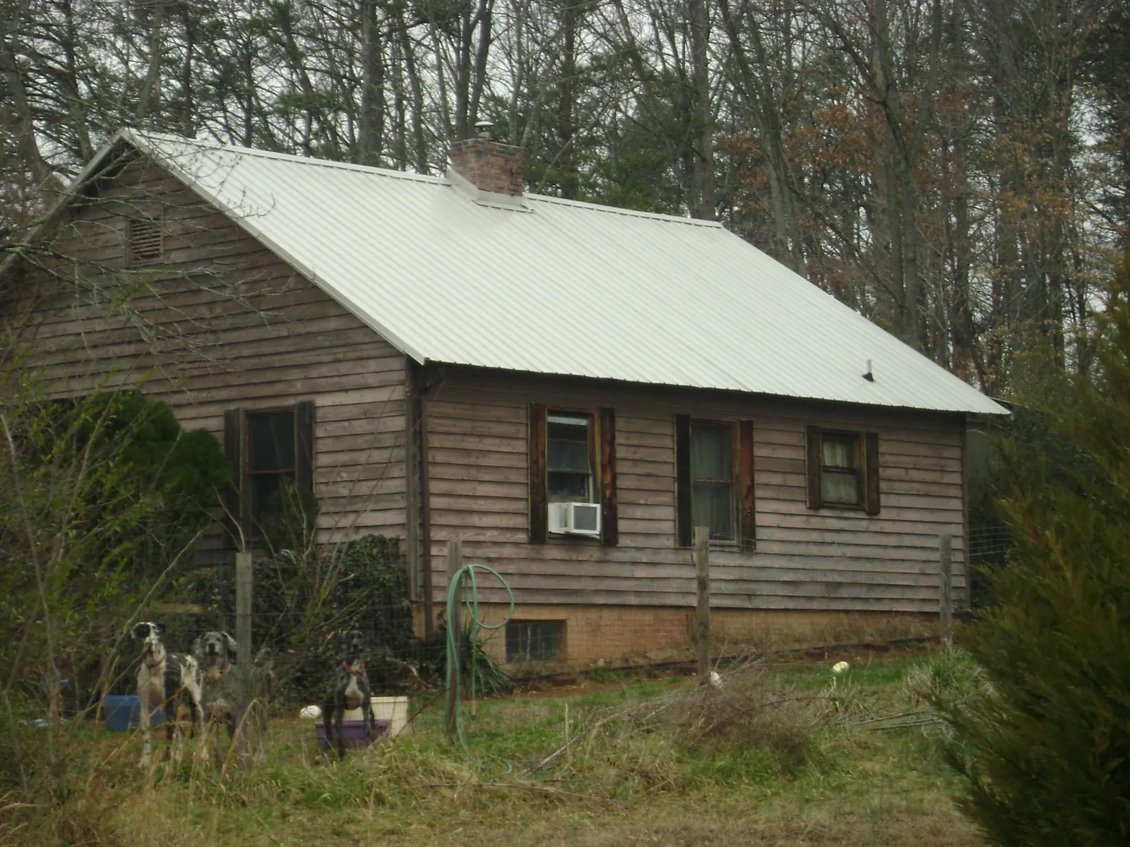 White metal roof on an old wood sided farmhouse, from a Metal Roof Installation job in Nephi